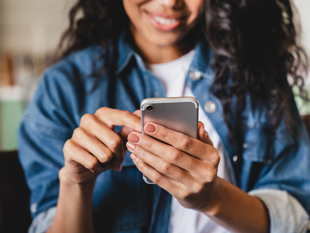 Woman accessing her retirement accounts with her phone