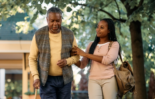 Older man walking with younger woman