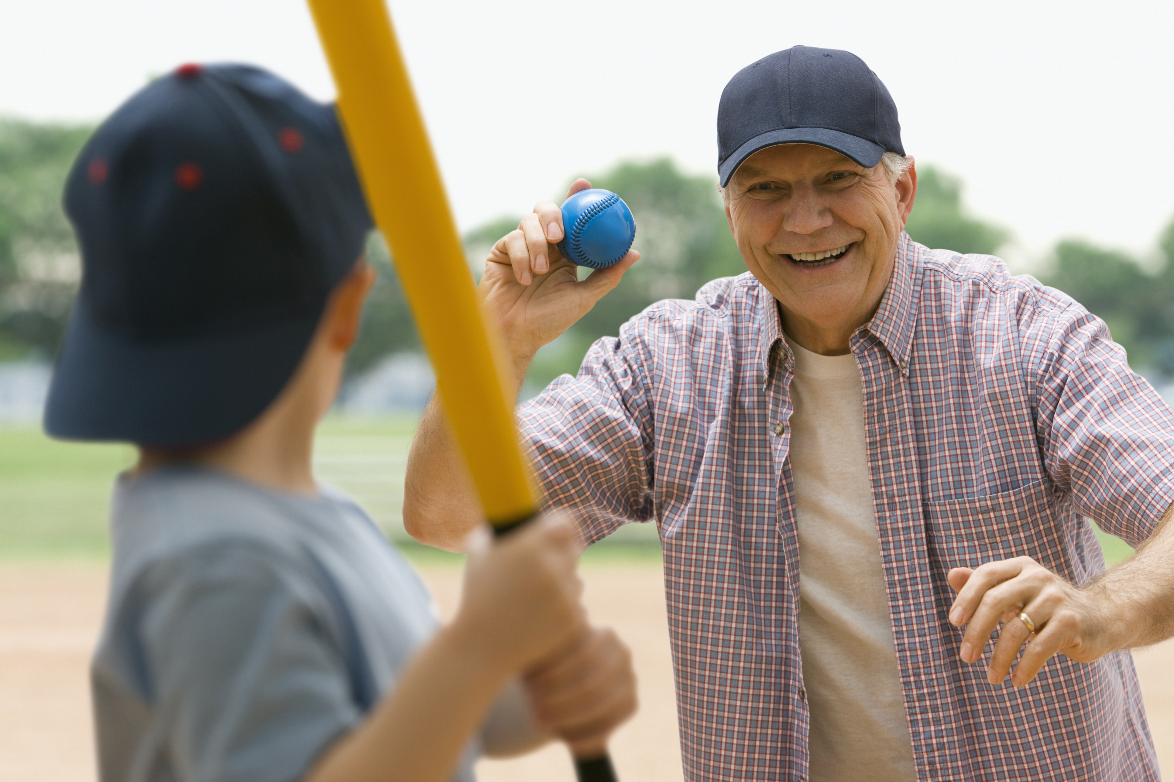 Grandfather and grandson playing baseball