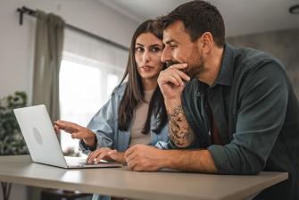 Man and woman looking at computer